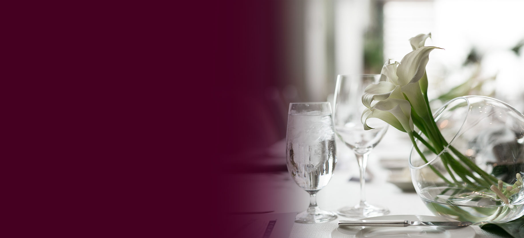 Floral arrangement on a table beside two glasses