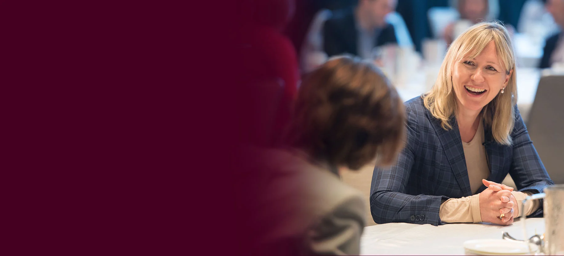 Anne Maggisano speaking with a guest at a Women of Burgundy event