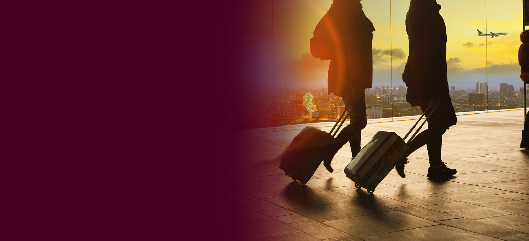 Two people pulling suitcases at an airport