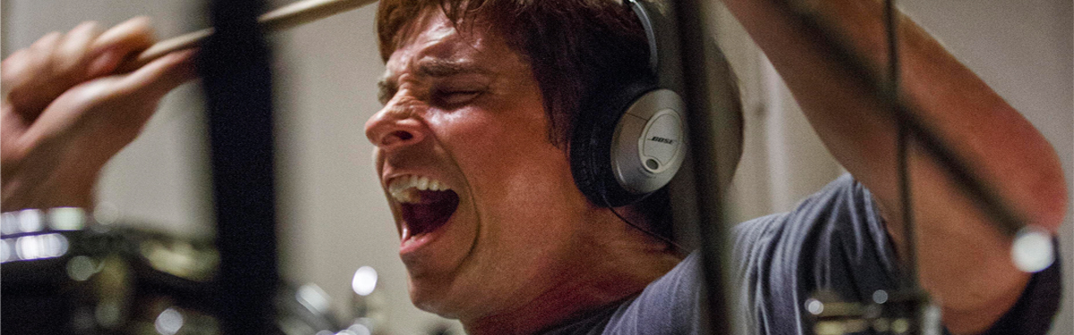Christian Bale as Mark Baum in the film "The Big Short," letting out his frustration by playing drums