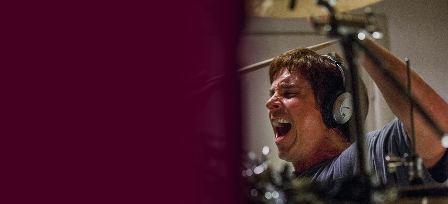 Christian Bale as Mark Baum in the film "The Big Short," letting out his frustration by playing drums