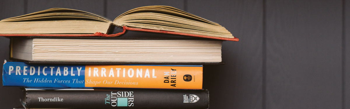 A stack of books featured in the Women of Burgundy bookclub