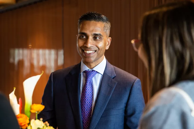 Mike Sandrasagra speaks with clients at a Burgundy event