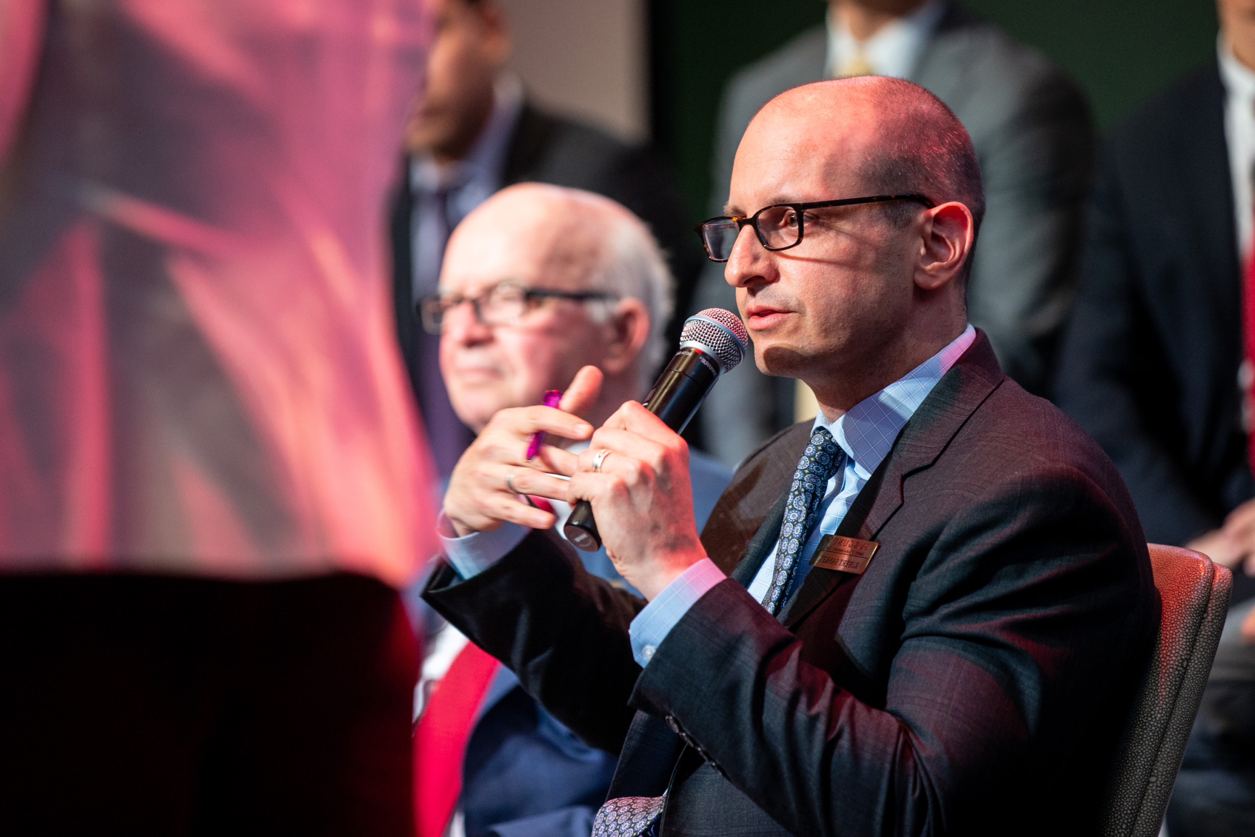 Rob Sankey speaks at the Montreal Forum Burgundy, with Tony Arrell sitting beside him