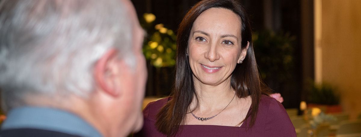 Julie Cordeiro in conversation with a client at a Burgundy event