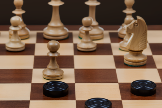 A chess board with chess pieces played against checkers pieces.