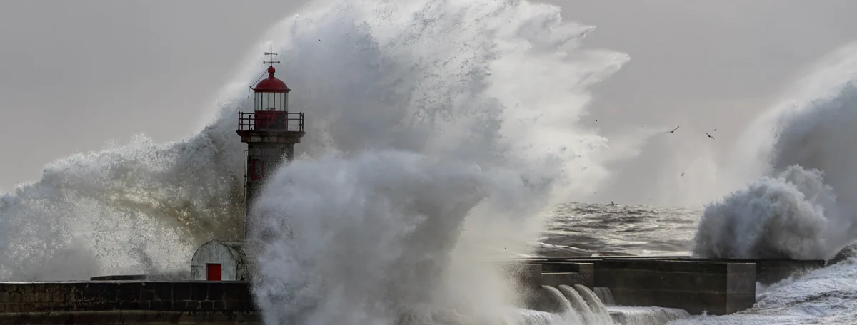 Wave crashing against lighthouse