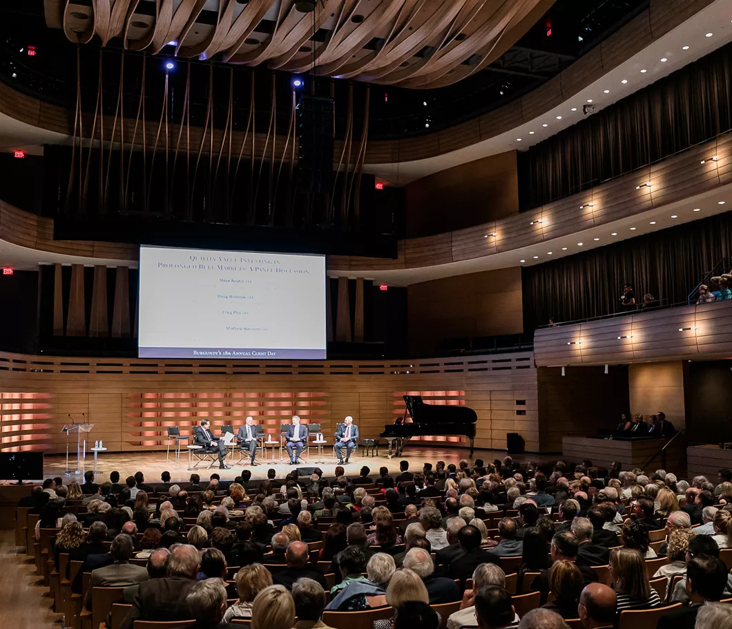 Burgundy team members speak onstage at the Burgundy Forum in front of a crowd