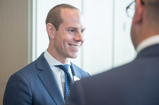 Ayrton Dick speaking with clients at the Burgundy Forum