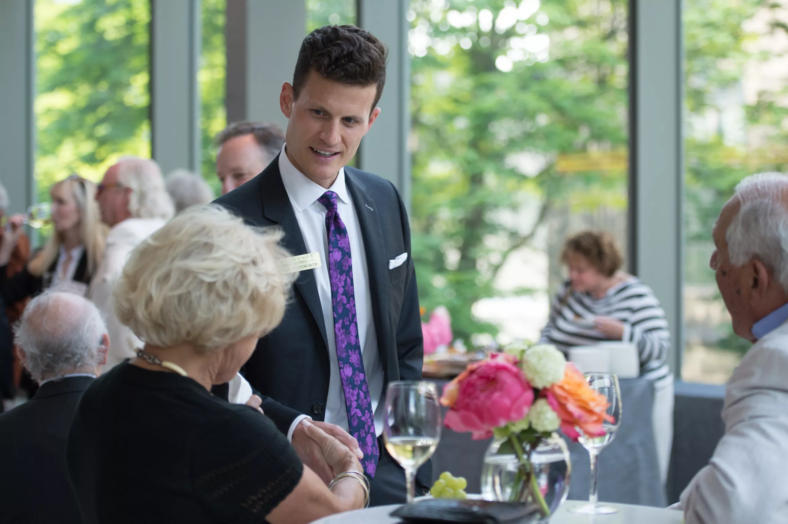 Kyle Coatsworth speaks with a client at the Burgundy Forum