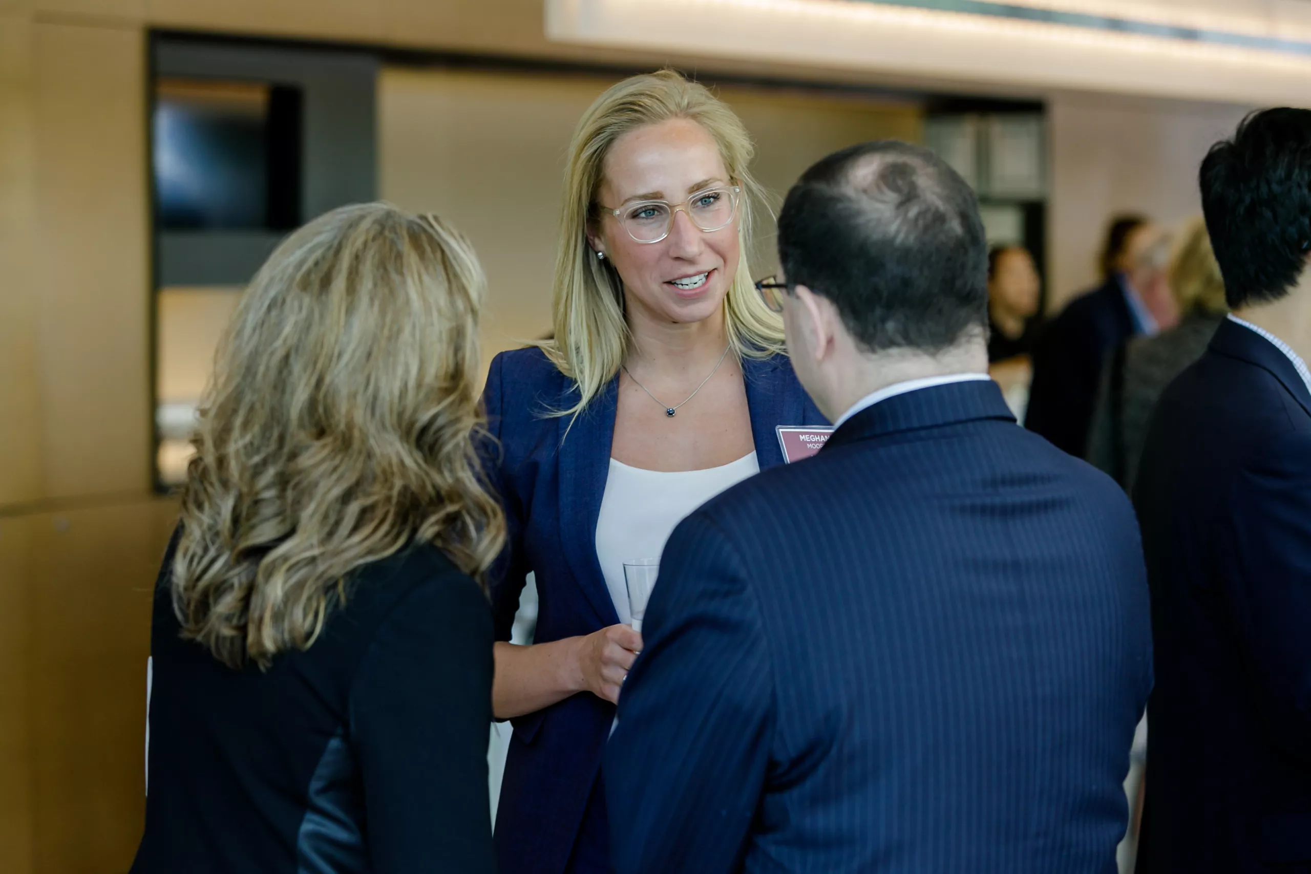 Meghan Moore speaks with clients at the Burgundy Forum