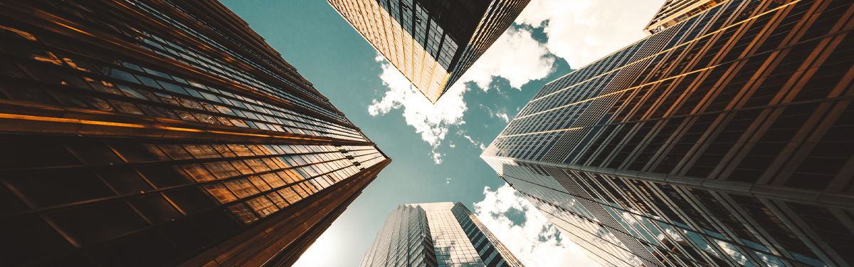 Looking up at the sky between tall buildings