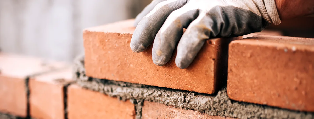 Close up of a construction worker laying bricks