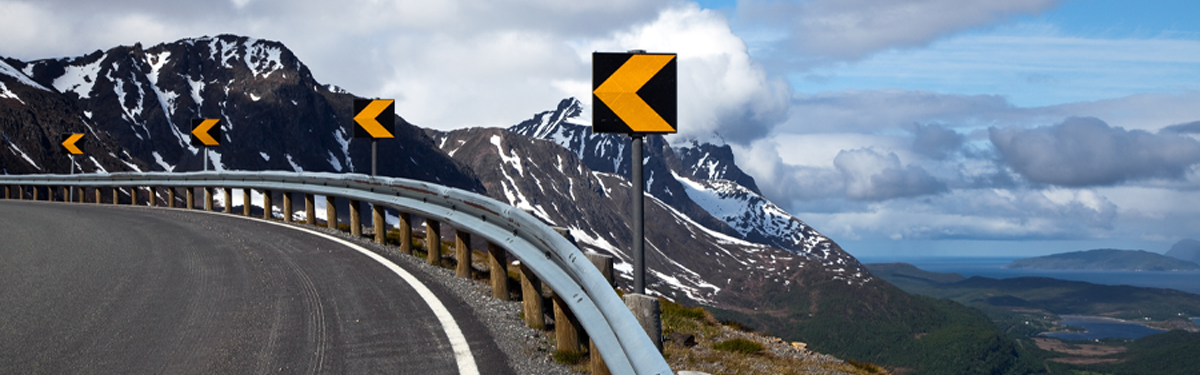 A bend in the road with mountains ahead