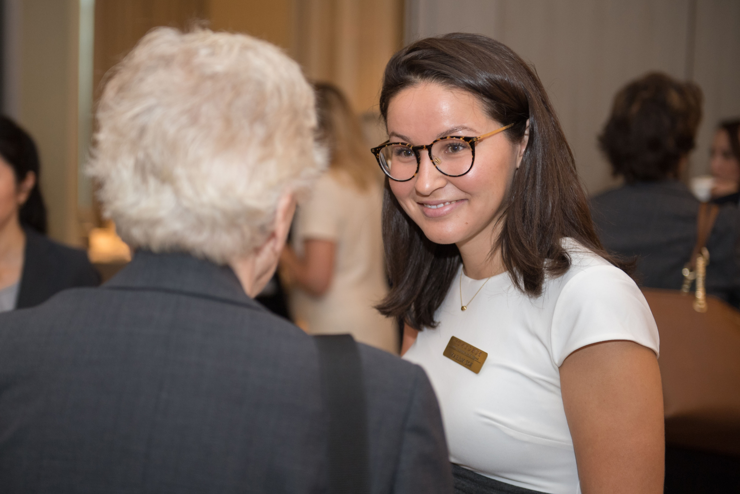 Roz McLean speaking with a client at a Women of Burgundy event