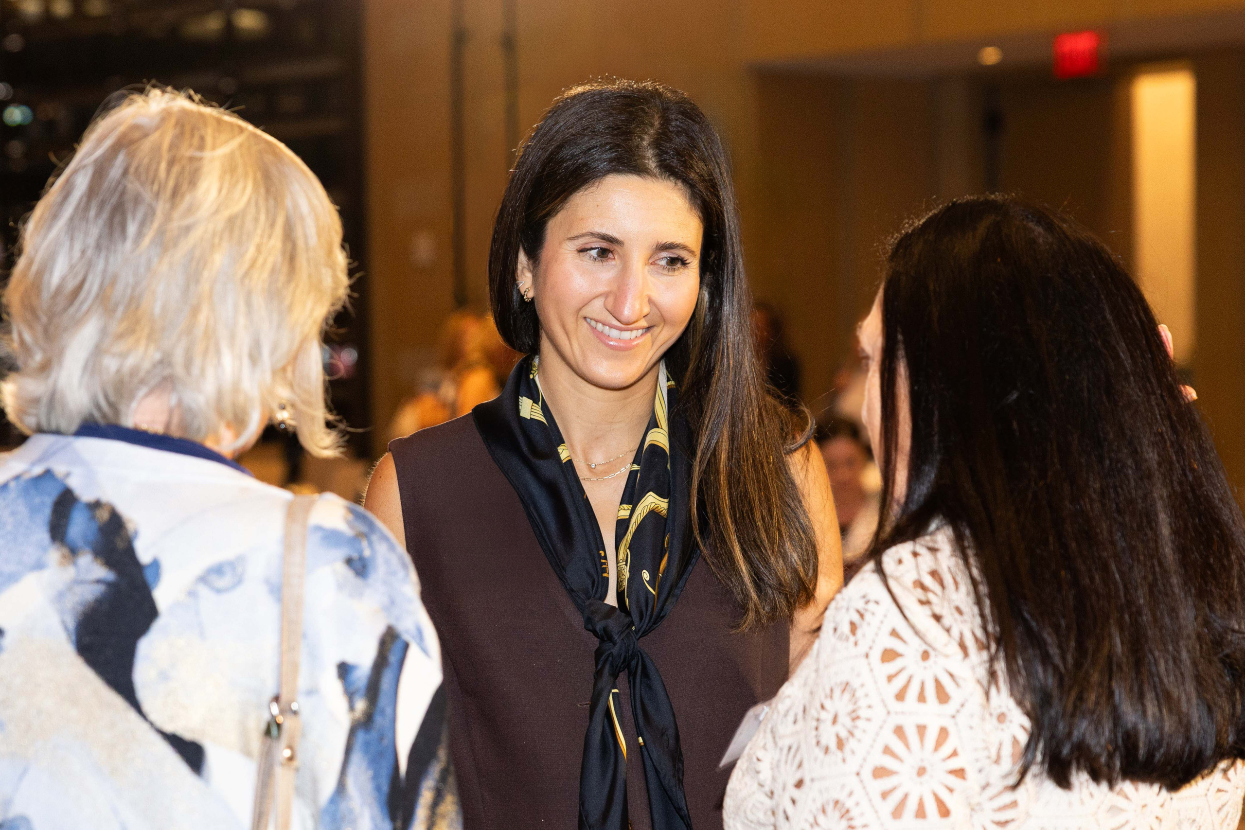 Lauren Landau speaks with clients at the Minerva Summit